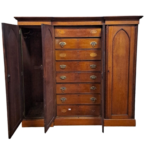 194 - A 19TH CENTURY GOTHIC DESIGN POLLARD OAK WARDROBE of inverted breakfront outline the moulded cornice... 