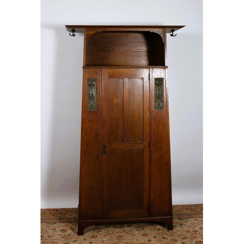 198 - AN ART NOUVEAU OAK WARDROBE of rectangular shaped outline the moulded cornice above an open compartm... 