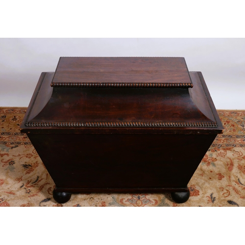 215 - A 19TH CENTURY MAHOGANY CETTARETT OF SARCOPHAGUS OUTLINE the hinged lid with compartments above a pa... 