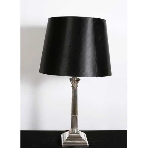 224 - A SILVER PLATED CORINTHIAN COLUMN TABLE LAMP the reeded column above a square stepped base with shad... 