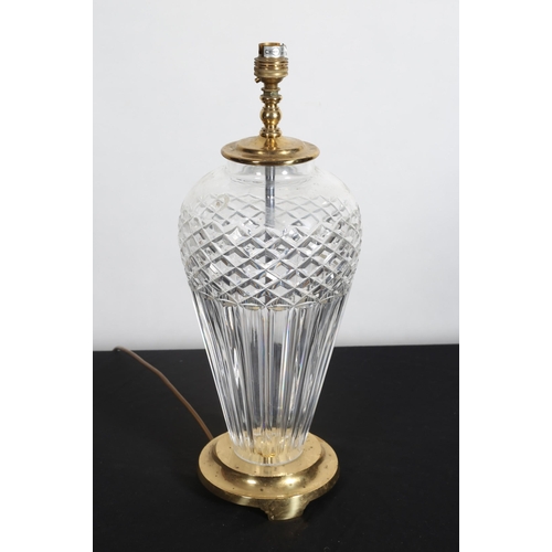 233 - A WATERFORD CUT GLASS AND GILT BRASS TABLE LAMP of ovoid tapering form raised on a shaped stepped fo... 