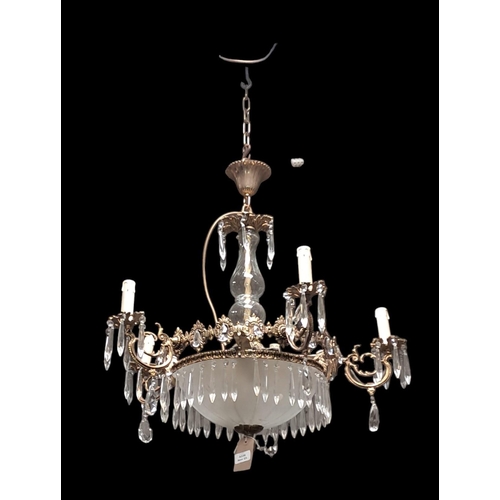 266 - A CONTINENTAL GILT BRASS CLEAR GLASS AND FROSTED GLASS CHANDELIER the baluster column above a froste... 