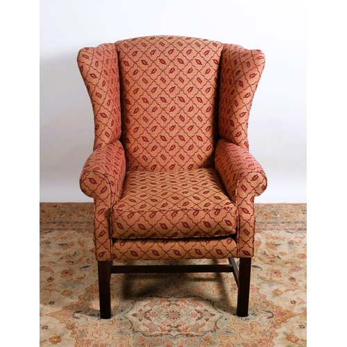 274 - A GEORGIAN DESIGN MAHOGANY AND UPHOLSTERED WING CHAIR with scroll over arms and loose cushion on squ... 