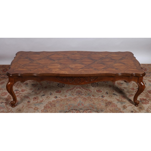 291 - A CONTINENTAL PARQUETRY COFFEE TABLE of serpentine outline the shaped top on cabriole legs with scro... 