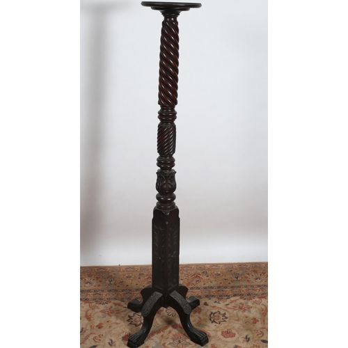 292 - A 19TH CENTURY CARVED MAHOGANY TORCHERE the circular dished top above a spiral twist carved column o... 