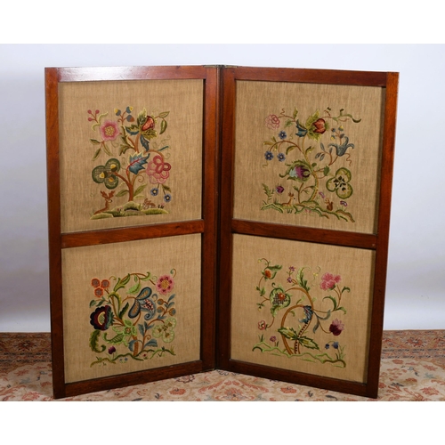 298 - A 19TH CENTURY MAHOGANY AND NEEDLEWORK UPHOLSTERED TWO FOLD SCREEN each panel decorated with floral ... 