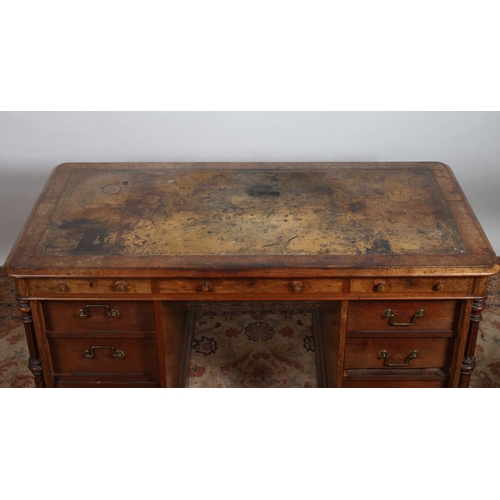 30 - A 19TH CENTURY WALNUT DESK of rectangular outline the shaped top with tooled leather inset above thr... 
