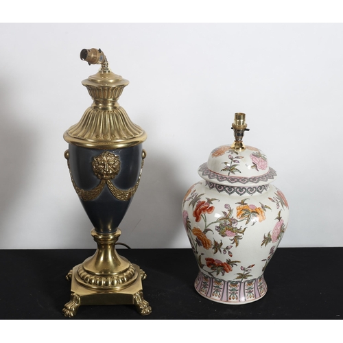 315 - A CONTINENTAL GILT BRASS AND POLYCHROME TABLE LAMP of urn form embossed with lion masks and drapery ... 