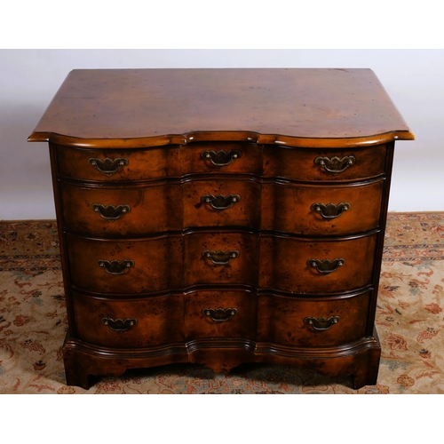 358 - A THEODORE ALEXANDER WALNUT CHEST each of serpentine outline the shaped top above four long graduate... 