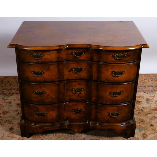 359 - A THEODORE ALEXANDER WALNUT CHEST each of serpentine outline the shaped top above four long graduate... 