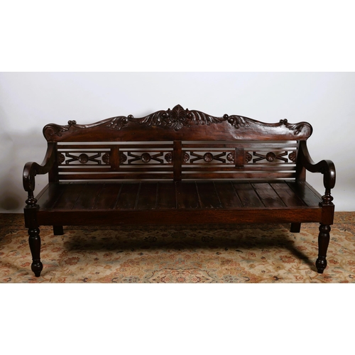 364 - A HARDWOOD BENCH the serpentine carved top rail above a pierced splat with planked seat and scroll a... 