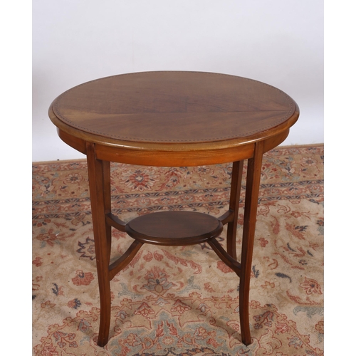 387 - AN EDWARDIAN MAHOGANY OCCASIONAL TABLE of oval outline the shaped top raised on square splayed legs ... 