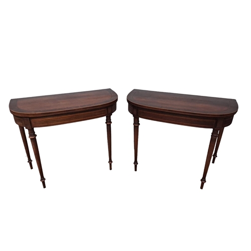 390 - A PAIR OF 19TH CENTURY MAHOGANY AND MAPLE CROSSBANDED FOLDOVER CARD TABLES each of demi lune outline... 