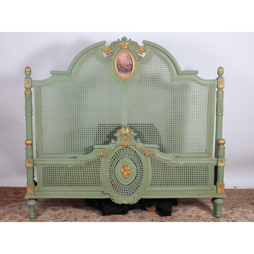 395 - A CONTINENTAL GREEN PAINTED AND PARCEL GILT BED the rectangular arched headboard with bergère panel ... 