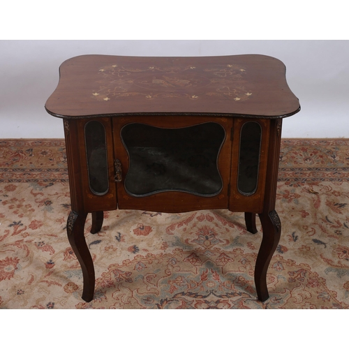 398 - AN EDWARDIAN MAHOGANY INLAID AND GILT BRASS MOUNTED CURIO CABINET of serpentine outline the shaped t... 