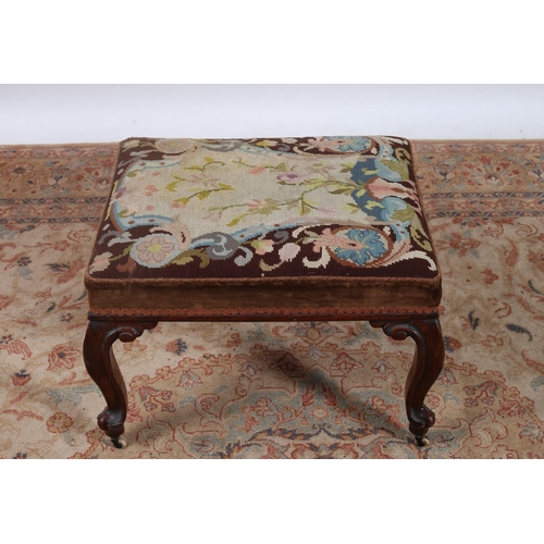 419 - A MAHOGANY STOOL the rectangular needlework upholstered seat raised on cabriole legs with brass and ... 