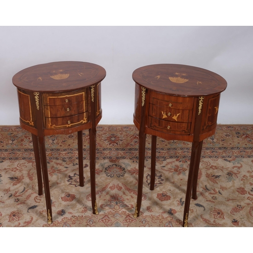 423 - A PAIR OF CONTINENTAL KINGWOOD AND GILT BRASS MOUNTED TABLES each of oval outline the shaped top's a... 