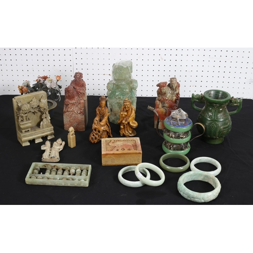 482 - A COLLECTION OF ORIENTAL CARVED FIGURES to include a jade example, two simulated marble seals, five ... 