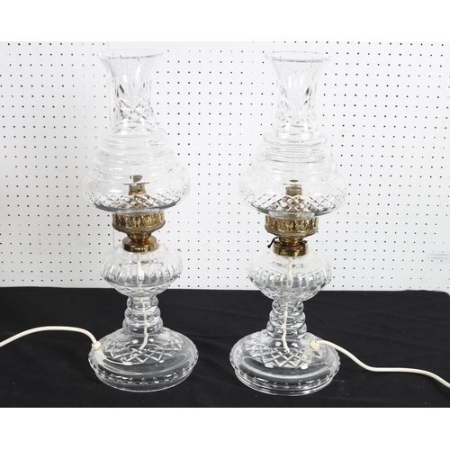 504 - A PAIR OF WATERFORD HURRICANE CUT GLASS AND GILT BRASS TABLE LAMPS each with an a shaped shade above... 