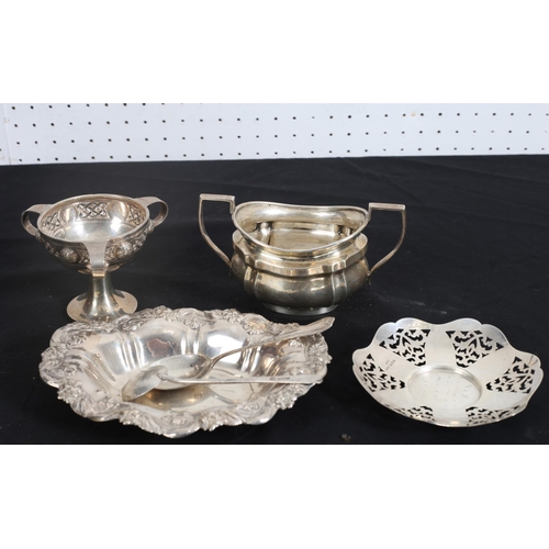 521 - A PIERCED SILVER BON BON DISH together with a miniature silver Celtic pattern trophy, a silver sugar... 