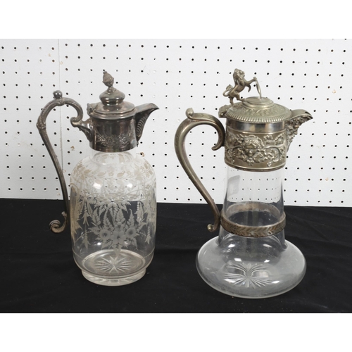 524 - A SILVER PLATED AND ENGRAVED CLARET JUG together with a similar example (2) 28cm (h) 27cm (h)