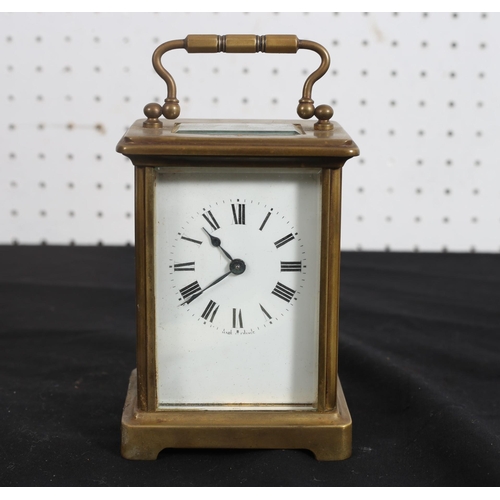 532 - A FRENCH BRASS CARRIAGE CLOCK with enamel dial and Roman numerals on bracket feet 
12cm (h) x 9cm (w... 