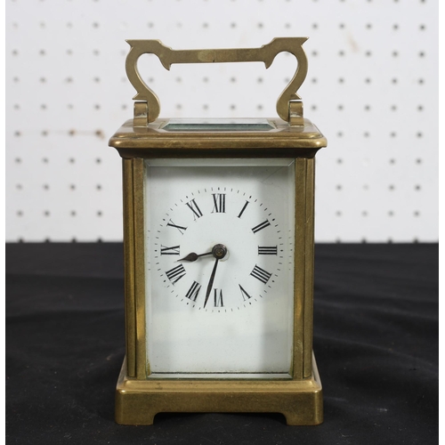 533 - A FRENCH BRASS CARRIAGE CLOCK with enamel dial and Roman numerals on bracket feet
14cm (h) x 9cm (w)... 