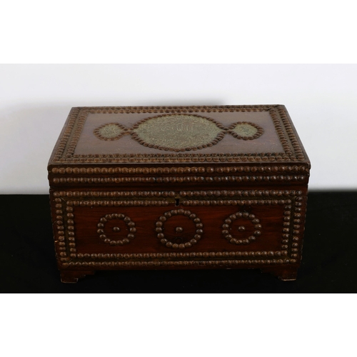 588 - A HARDWOOD CASKET of rectangular outline inset with studs and brass carrying handles on bracket feet... 