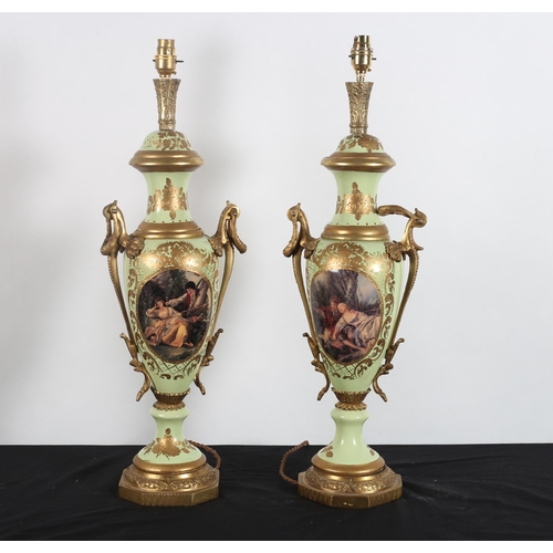 590 - A PAIR OF CONTINENTAL GILT BRASS AND PORCELAIN TABLE LAMPS each of urn form the light green and gilt... 