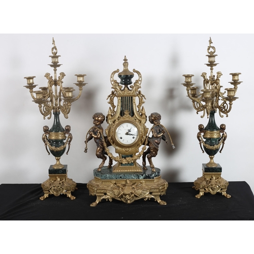 591 - A THREE PIECE CONTINENTAL GILT BRASS AND BRONZE MARBLE CLOCK GARNITURE the shaped lyre case surmount... 