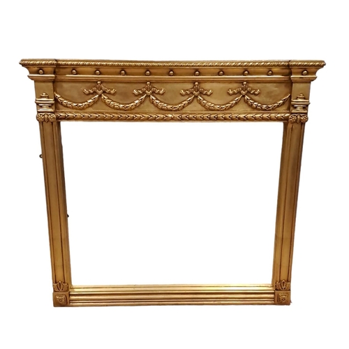 616 - A REGENCY DESIGN GILT FRAME OVERMANTEL MIRROR the rectangular plate within a pilaster frame with urn... 