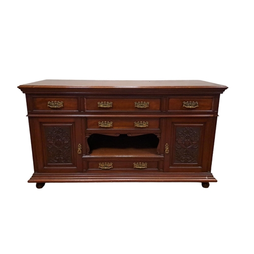 62 - AN EDWARDIAN MAHOGANY SIDEBOARD of rectangular outline the shaped top above an arrangement of five d... 