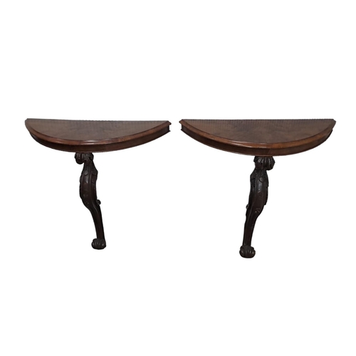 640 - A PAIR OF VICTORIAN WALNUT AND MAHOGANY CONSOLE TABLES each of demi lune outline the shaped top rais... 