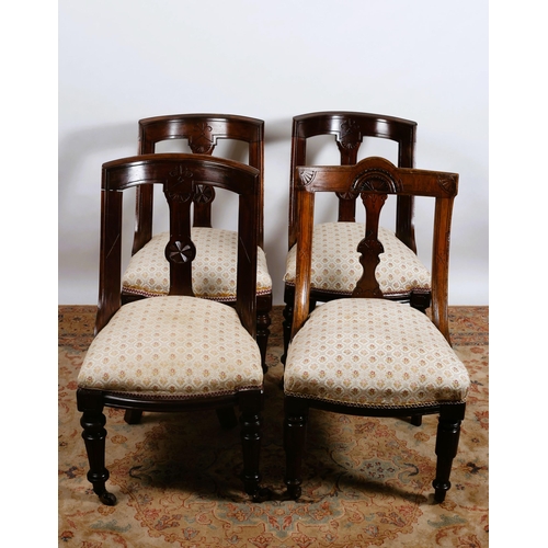 647 - A SET OF THREE EDWARDIAN CARVED MAHOGANY DINING CHAIRS each with a curved back and upholstered seat ... 