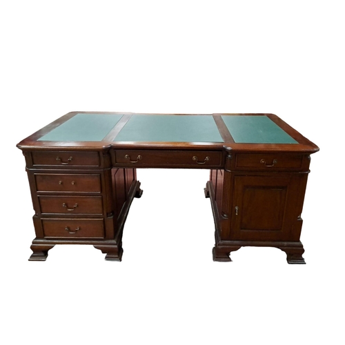 67 - A GEORGIAN DESIGN MAHOGANY PARTNERS DESK of rectangular breakfront outline the shaped top with three... 