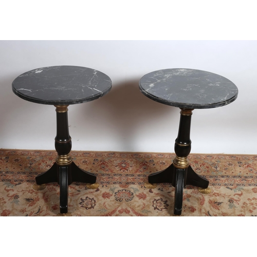 74 - A PAIR OF CONTINENTAL EBONISED PARCEL GILT AND MARBLE TABLES each with a circular veined marble top ... 