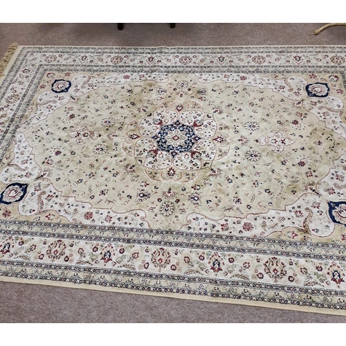 745 - A BEIGE AND LIGHT GREEN GROUND PATTERN RUG the central panel filled with stylised flowerheads and fo... 