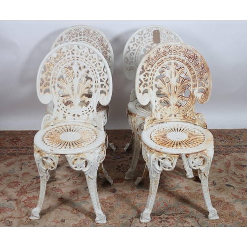 750 - A SET OF FOUR CAST IRON PATIO CHAIRS each with a pierced shaped back and seat on splayed legs with s... 