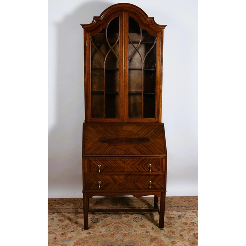 751 - A VINTAGE MAHOGANY BUREAU BOOKCASE of rectangular arched form the shaped cornice above a pair of ast... 