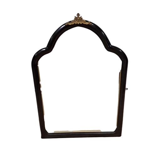 763 - A CONTINENTAL EBONISED AND GILT BRASS MOUNTED MIRROR the rectangular arched bevelled glass plate wit... 