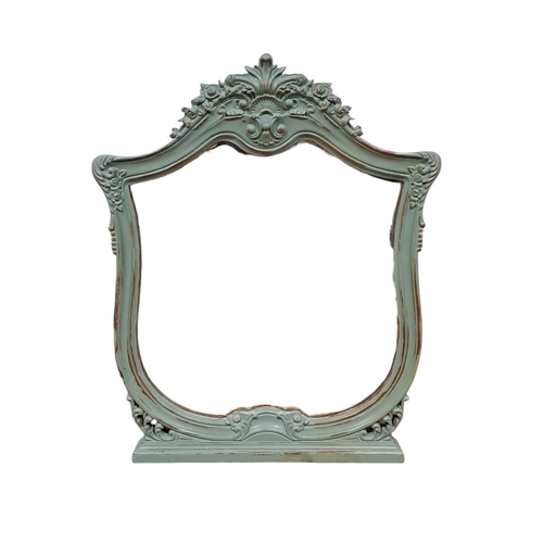 765 - A CONTINENTAL GREEN PAINTED MIRROR the shaped plate within a flowerhead and foliate carved frame wit... 