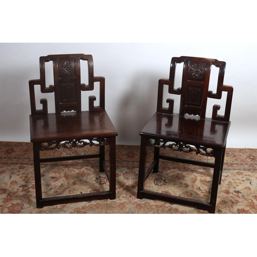 78 - A PAIR OF ORIENTAL HARDWOOD CHAIRS each with a rectangular stepped and pierced back with foliate car... 