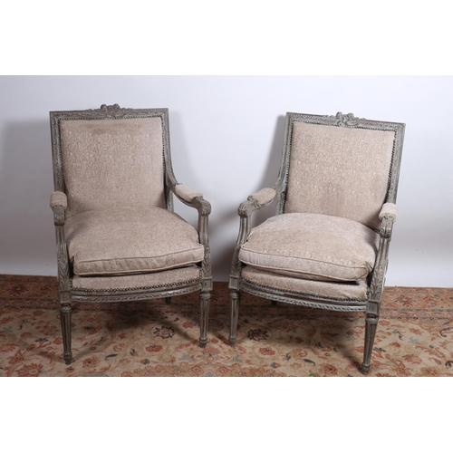 80 - A PAIR OF CONTINENTAL CARVED WOOD PAINTED AND UPHOLSTERED CHAIRS each with a foliate carved top rail... 