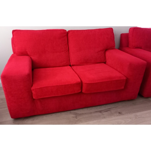 806 - A RED UPHOLSTERED SETTEE of rectangular outline with loose cushions 92cm (h) 164cm (w) 85cm (d)