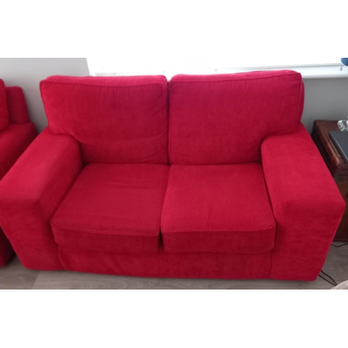 806 - A RED UPHOLSTERED SETTEE of rectangular outline with loose cushions 92cm (h) 164cm (w) 85cm (d)