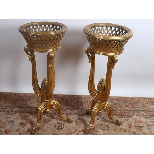 81 - A PAIR OF CONTINENTAL GILTWOOD JARDINIERE STANDS each of circular outline the reeded rim above a lat... 