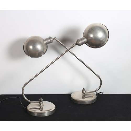 208 - A PAIR OF VINTAGE CHROME TABLE LAMPS each with a tubular arm with adjustable shade raised on a circu... 