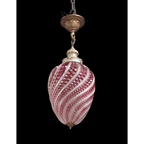 348 - A CRANBERRY GLASS AND FROSTED GLASS CENTRE LIGHT of ovoid spiral twist tapering form 
70cm drop