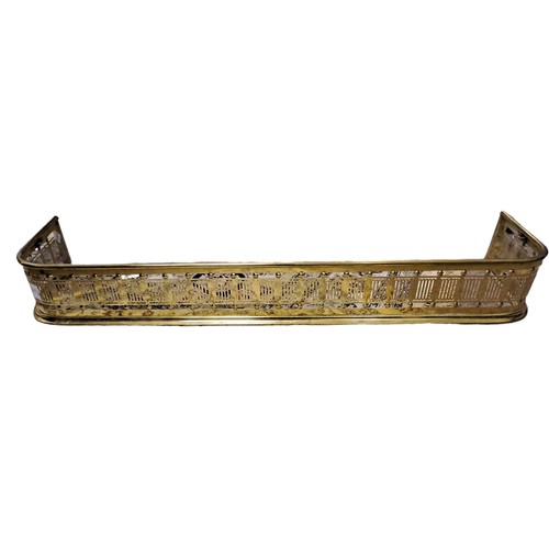 809 - A BRASS FENDER with pierced frieze raised on a stepped moulded platform 
15cm (h) x 124cm (w) x 30cm... 