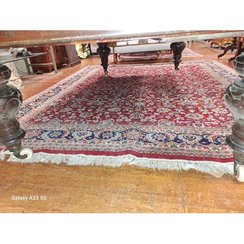 577 - A KESHAN WOOL RUG the wine ground with central floral panel within a conforming border 
315cm (l) x ... 